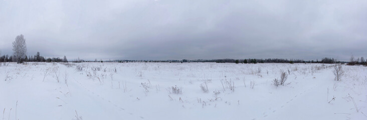 A snowy field in cloudy weather