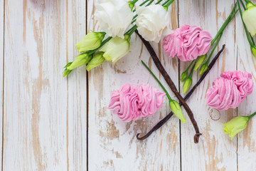 Homemade marshmallow dessert, vanilla sticks and white eustoma flowers.