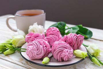 Homemade marshmallow dessert, vanilla sticks and white eustoma flowers.