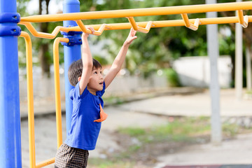 Young boy play with yellow bar