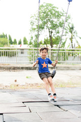 young asian boy play a iron chain swinging