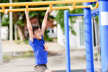 Fototapeta premium Young boy play with yellow bar