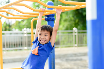 Fototapeta premium Young boy play with yellow bar
