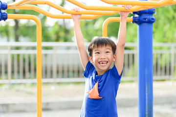 Fototapeta premium Young boy play with yellow bar