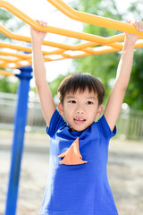 Fototapeta premium Young boy play with yellow bar