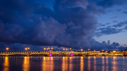 Fototapeta na wymiar Night cityscape with river and bridge in Saint-Petersburg.