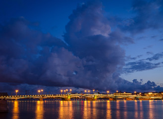 Night cityscape with river and bridge in Saint-Petersburg.