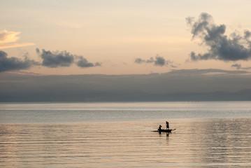 Silhouette of fishermen at sunrise