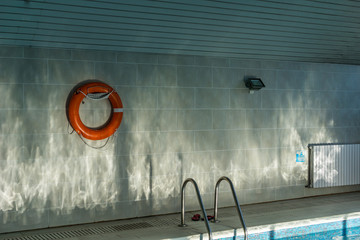 water reflecting sun on a swimming pool wall