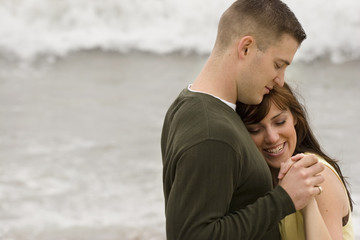 Couple share romantic moments on the beach.