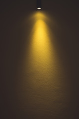 Light on yellow wall background