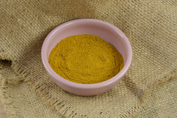 Bowl of ground Madras hot curry spice in bowl