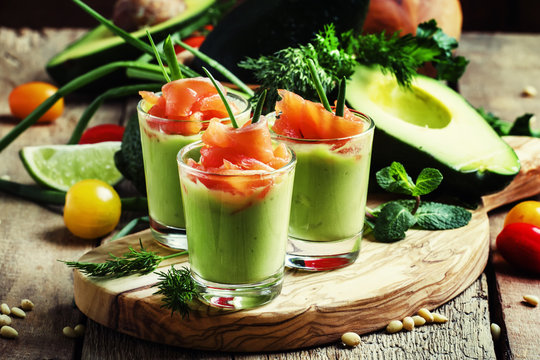Fototapeta Appetizer with salted salmon and avocado with green onion, selective focus