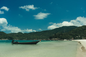 Fototapeta na wymiar Beach and tropical sea with long-tail boat in thailand