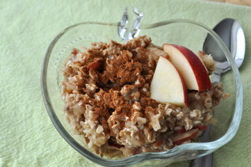 Healthy breakfast - oat flakes with grated apple and mashed banana sprinkled with cinnamon
