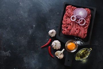 Raw ground beef meat, scratched metal background with copy space