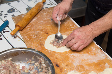 man prepares dumplings at home