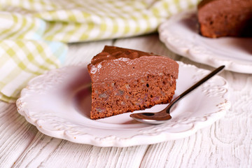 Delicious chocolate cake on plate on table on light background