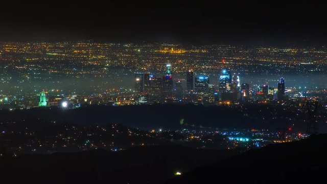Timelapse of Los Angeles Skyline at night in Storm Clouds -Pan Right-