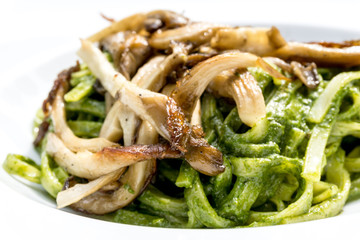 Pasta with pesto sauce and nuts on a the table