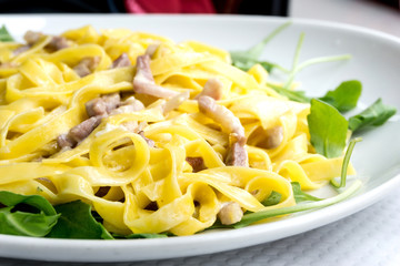 tasty pasta with roast ham on the table