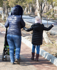 family with children walks in park