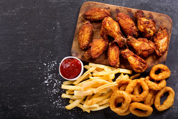 fast food meals : onion rings, french fries and fried chicken