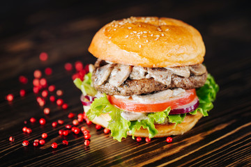 Burger with mushrooms, meatballs, tomato and lettuce with red bell pepper