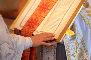 priest hand on open bible