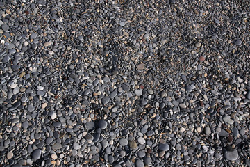 Black pebbles on the beach in Antibes. Cote d’Azur, France