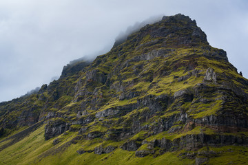 Cloud covered rocky mountain in Iceland