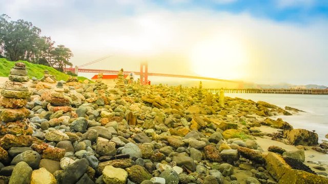 Time lapse of Golden Gate Bridge sun moning in the fog from Crissy Field popular beach park for locals and tourists. Leisure and recreational activities concept. San Francisco, United States