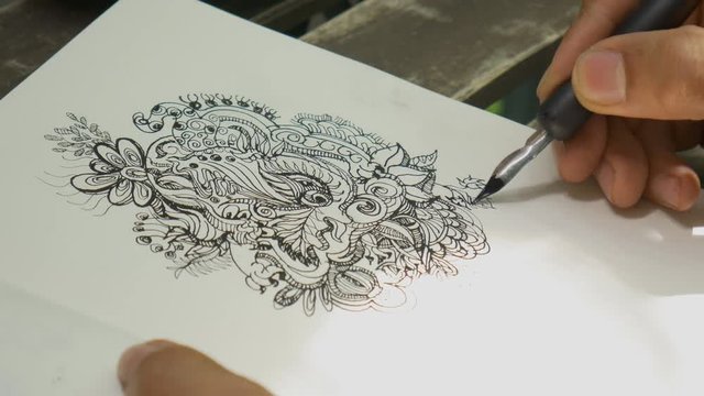 Closeup artist drawing doodle line art wtih black ink