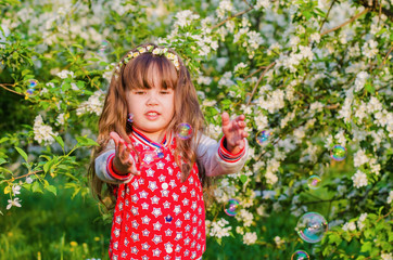 girl playing with soap bubbles