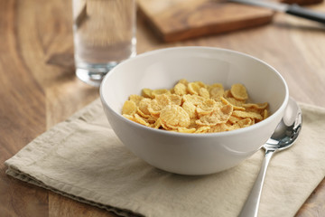 dry corn flakes for breakfast in bowl on table