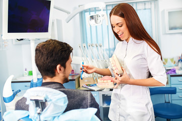 Professional woman dentist doctor working . man at dental clinic. man at dentist taking care of...