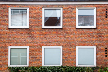 Fototapeta na wymiar Red brick wall with square windows