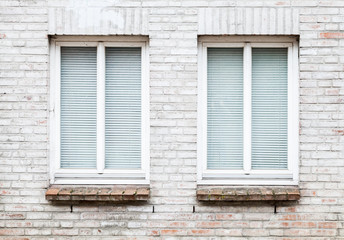 Fototapeta na wymiar Texture of brick wall with two windows