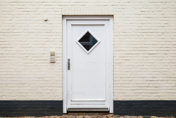 White wooden door in brick wall, texture