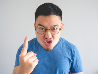 Funny face of angry Asian man.
