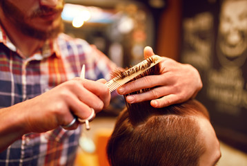 Time for a new hairdo. Handsome young bearded man came to the barber for a haircut.
hipster style. the concept of fashion and beauty.

