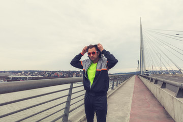 Urban jogger preparing for workout on the bridge.