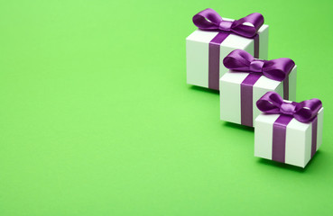 Gifts with satin bows on green