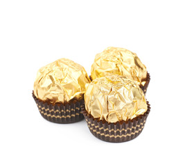 Pile of golden confection candies isolated