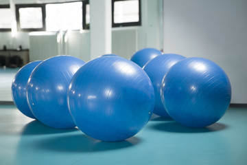 Group of blue pilates balls in the gym