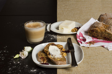 a rustic breakfast table with homemade bread, coffee and butter in a geometric order