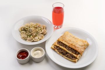 Dinner with dumplings and crepe filled with meat
