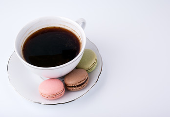 Coffee mug and Cake macaron on white background, sweet and colorful dessert.