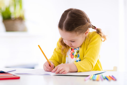 Kids read, write and paint. Child doing homework.