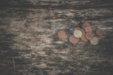 Money on the old wooden table. Euro coins from different countries.